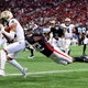 The Saints’ Chris Olave pulls down a two-point conversion pass against the Falcons’ Jaylinn Hawkins